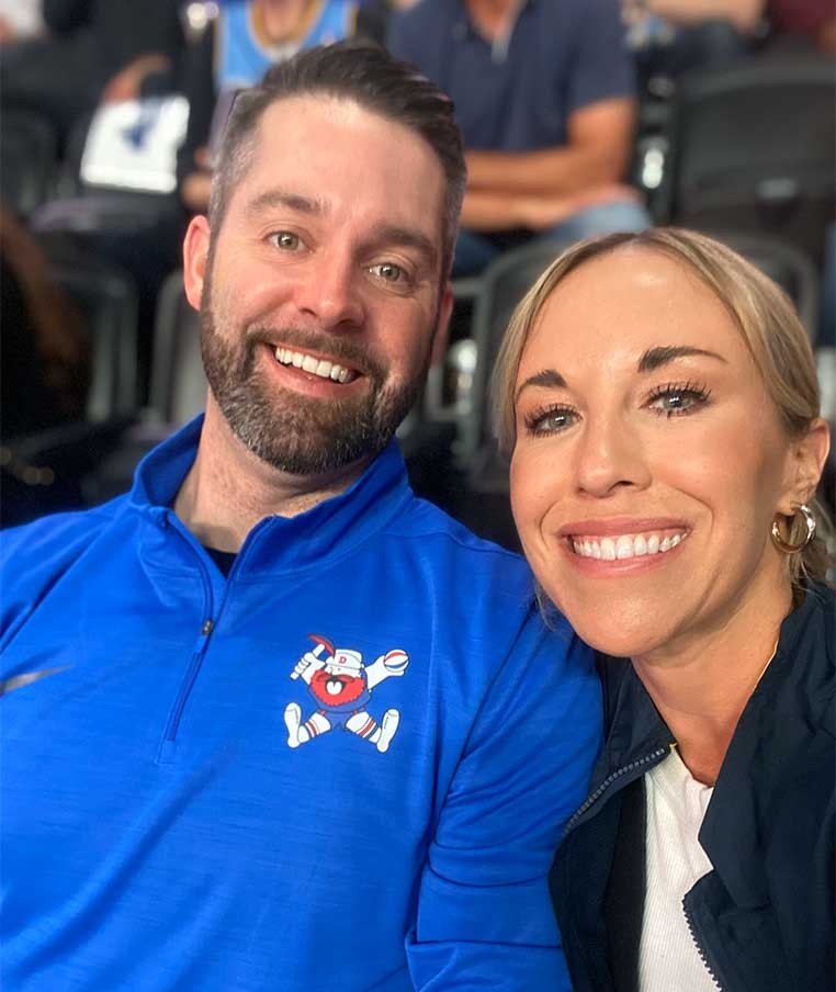 A man and woman leaning in for a photo together